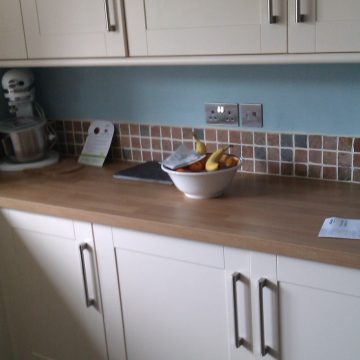 Stylish brushed steel sockets for kitchen electrics